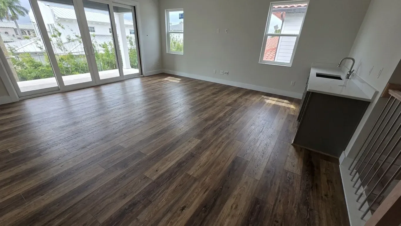 The same Seffner living area after installation, with dark wood-look LVP flooring throughout